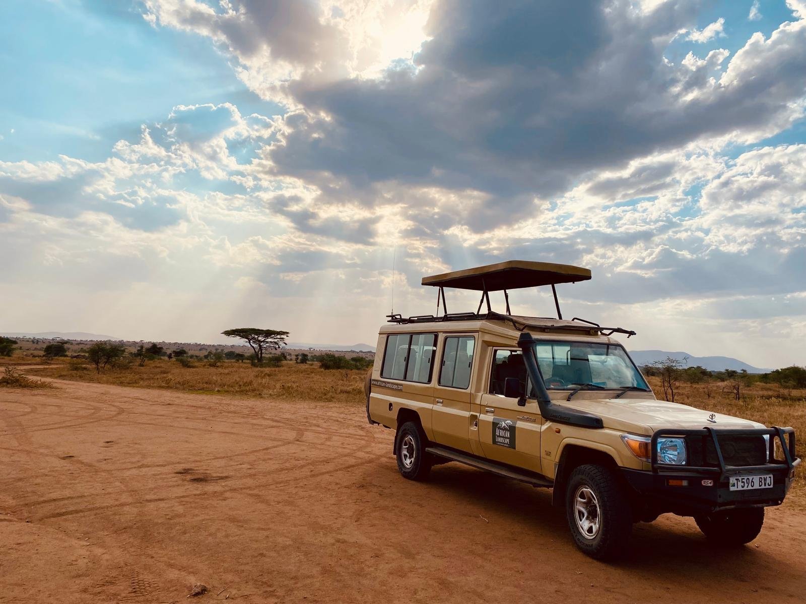 Safari guests enjoying a game drive from a Tanzania safari vehicle